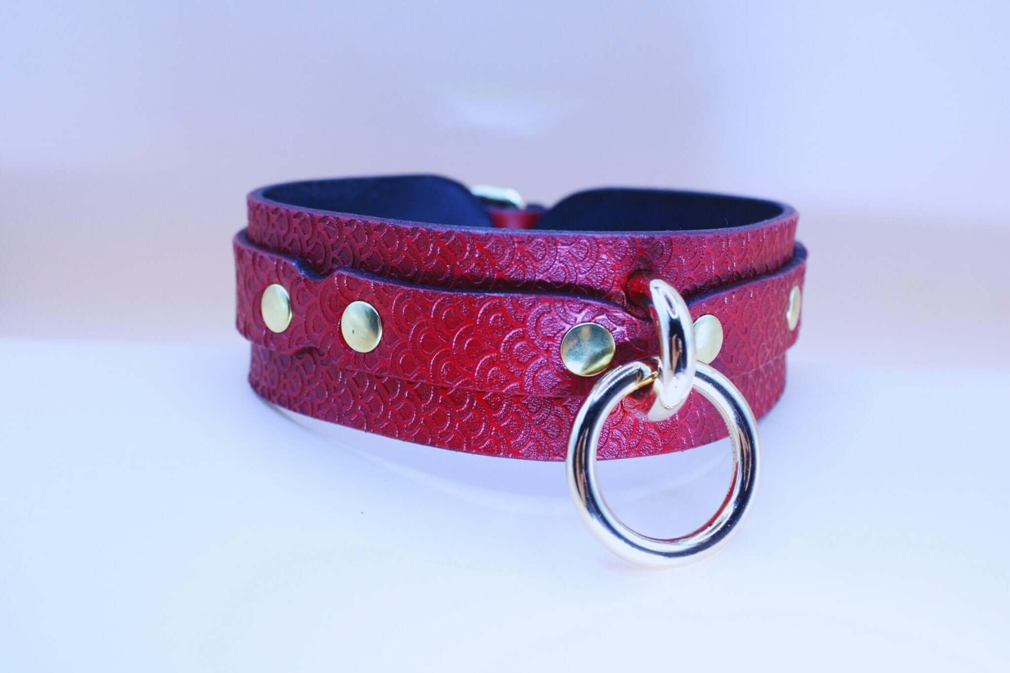Deep crimson red submissive collar with embossed pattern and silver O-ring, perfect for BDSM and bondage styles.