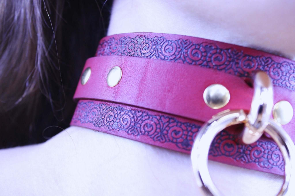 Red submissive collar with gothic pattern, gold studs, and metal ring, perfect for BDSM and bondage aesthetics.