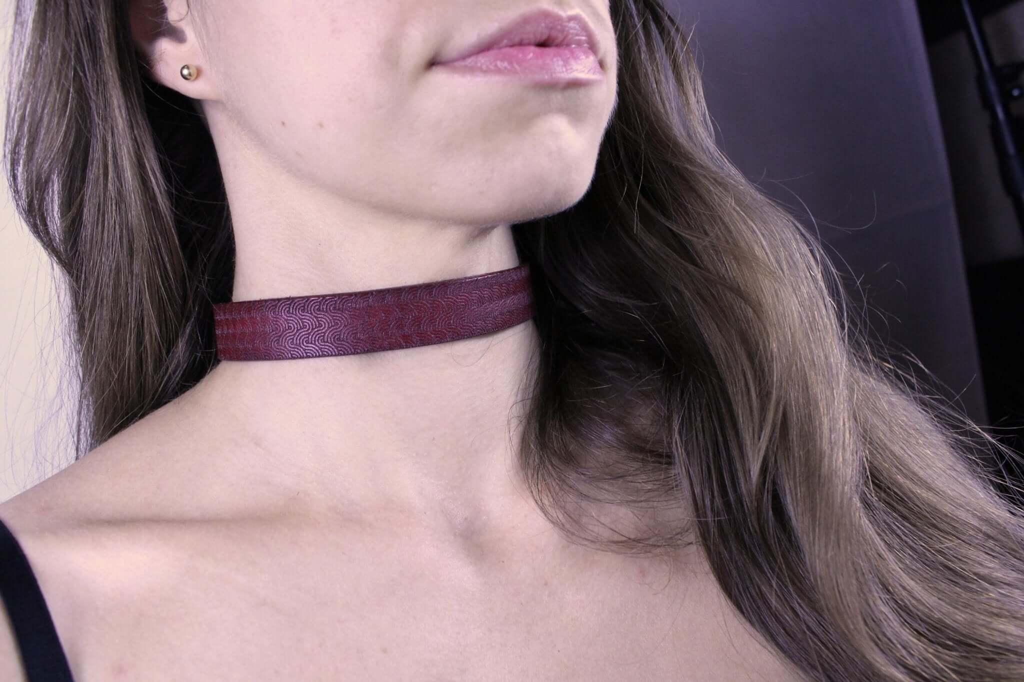 Elegant red patterned sub collar worn as a discreet day collar, perfect for BDSM jewelry and submissive aesthetics.