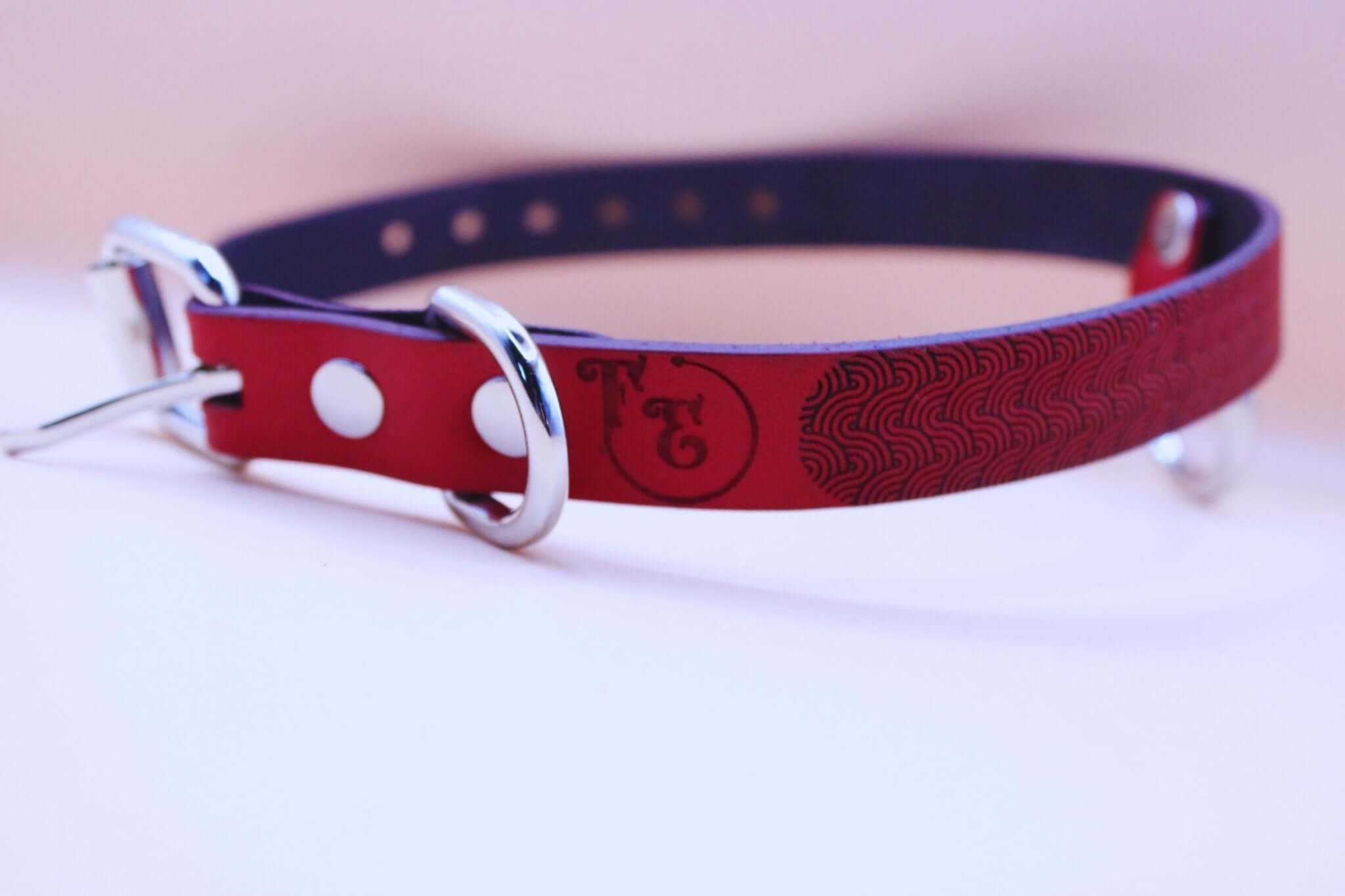 Red patterned leather BDSM collar with O-ring, perfect for submissive style and bondage jewelry.