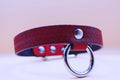Red patterned leather submissive collar with O-ring, perfect for BDSM and bondage styles.