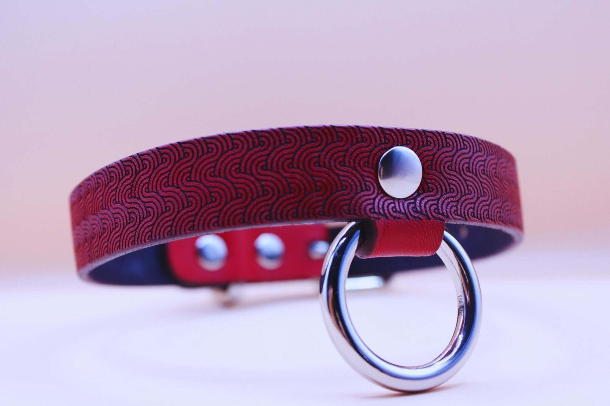 Red patterned leather submissive collar with O-ring, perfect for BDSM and bondage styles.