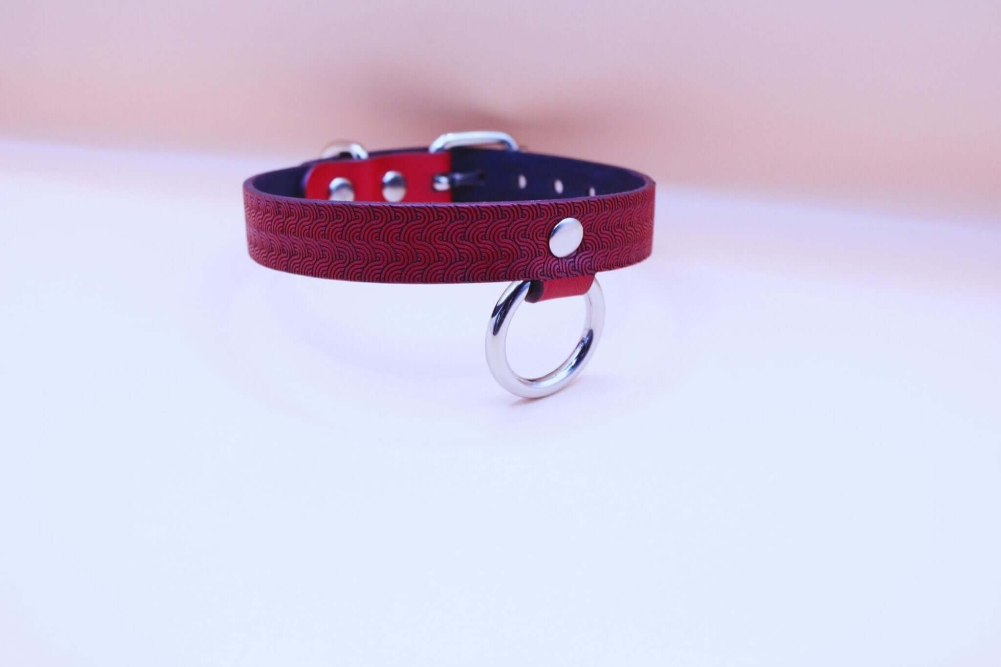 Red patterned leather submissive collar with O-ring, perfect for BDSM, bondage gear and discreet day collar.