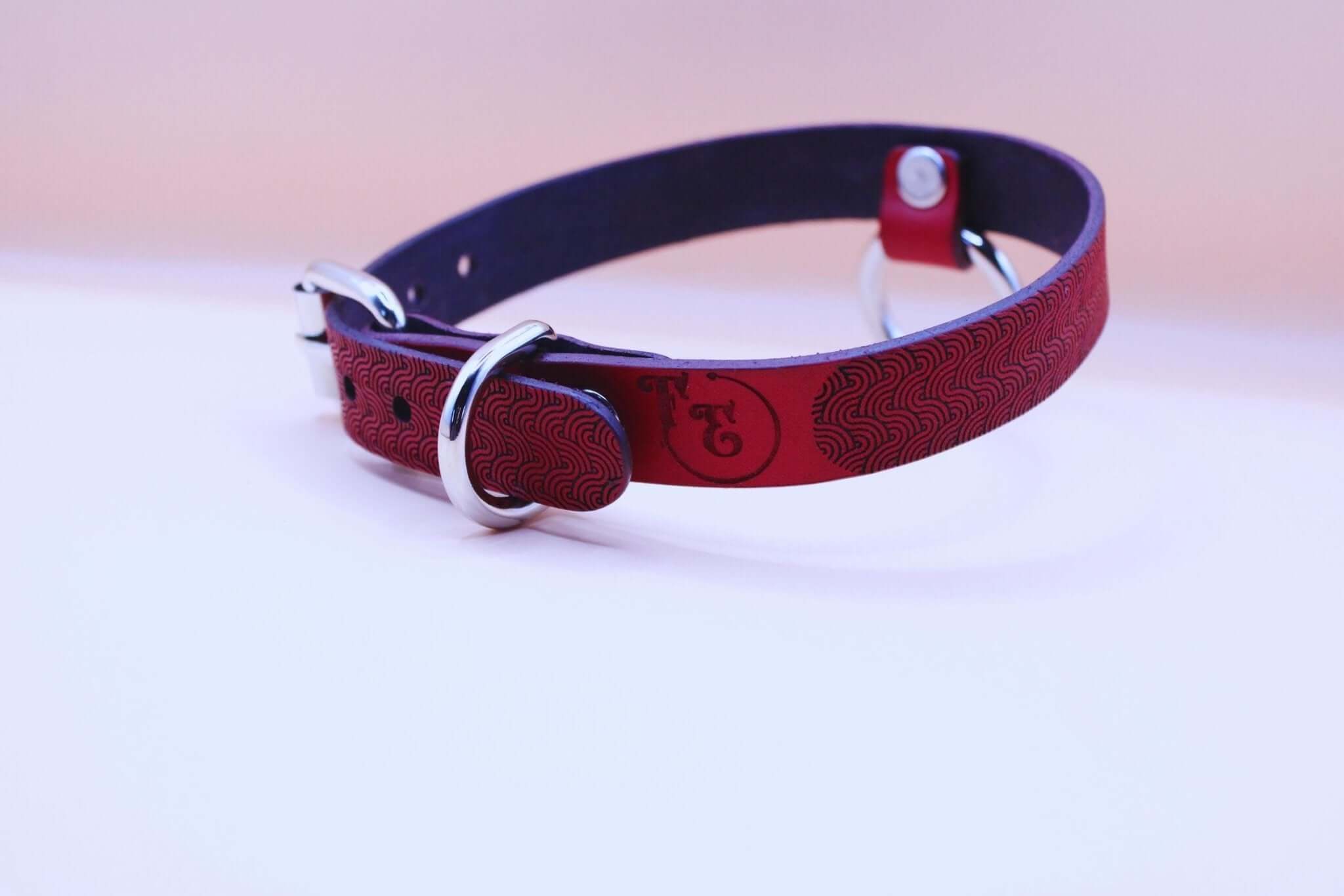 Red patterned leather submissive collar with O-ring, crafted for BDSM, bondage gear, and erotic fashion enthusiasts.