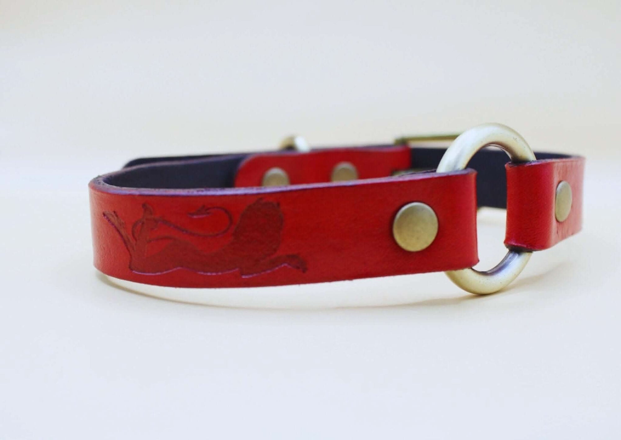 Red leather BDSM collar with embossed feline silhouette, elegant day collar for submissive jewelry and bondage gear.