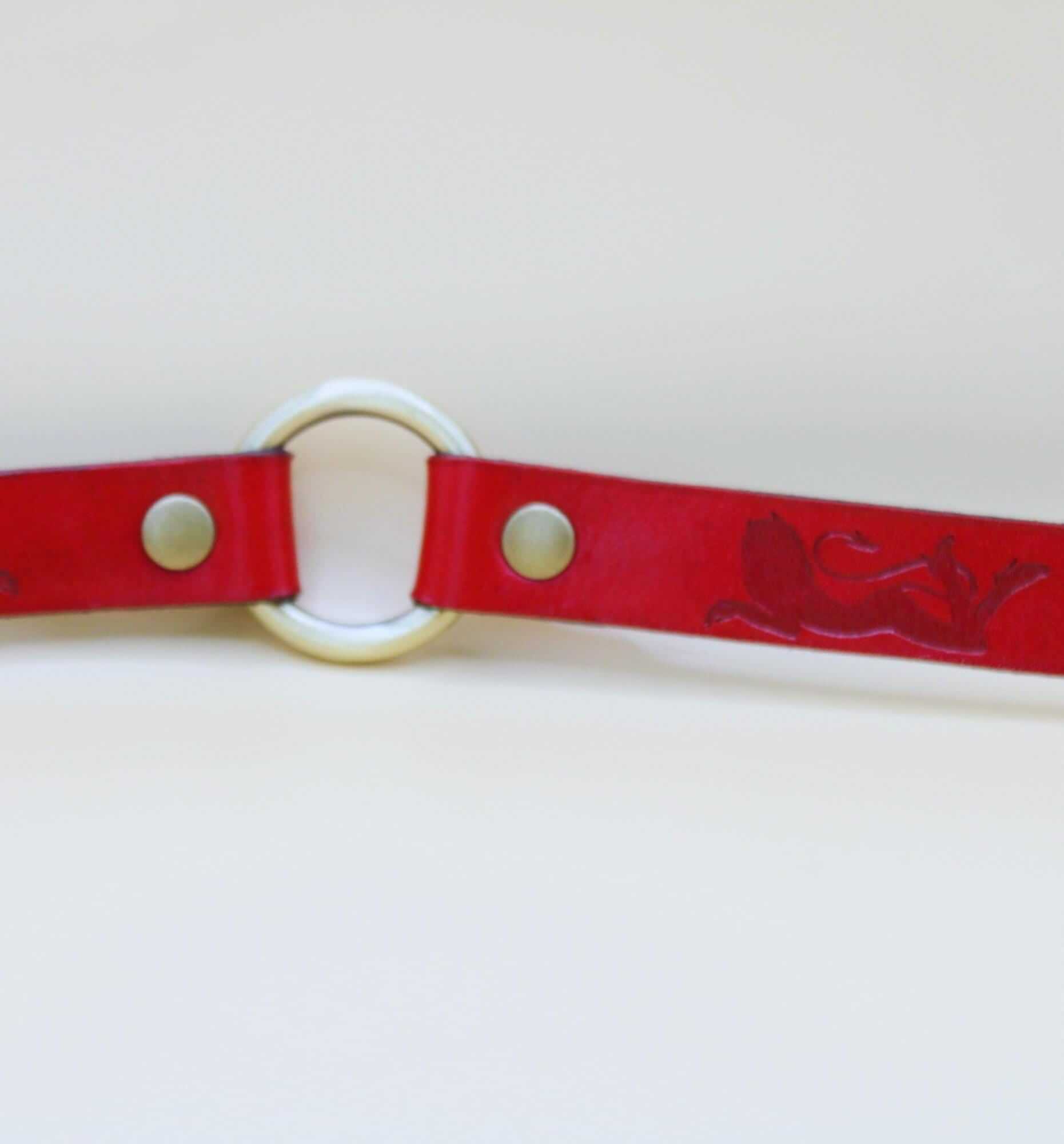 Elegant red leather submissive collar with embossed feline design, perfect for BDSM and everyday wear, ideal for sub collar discreet use.