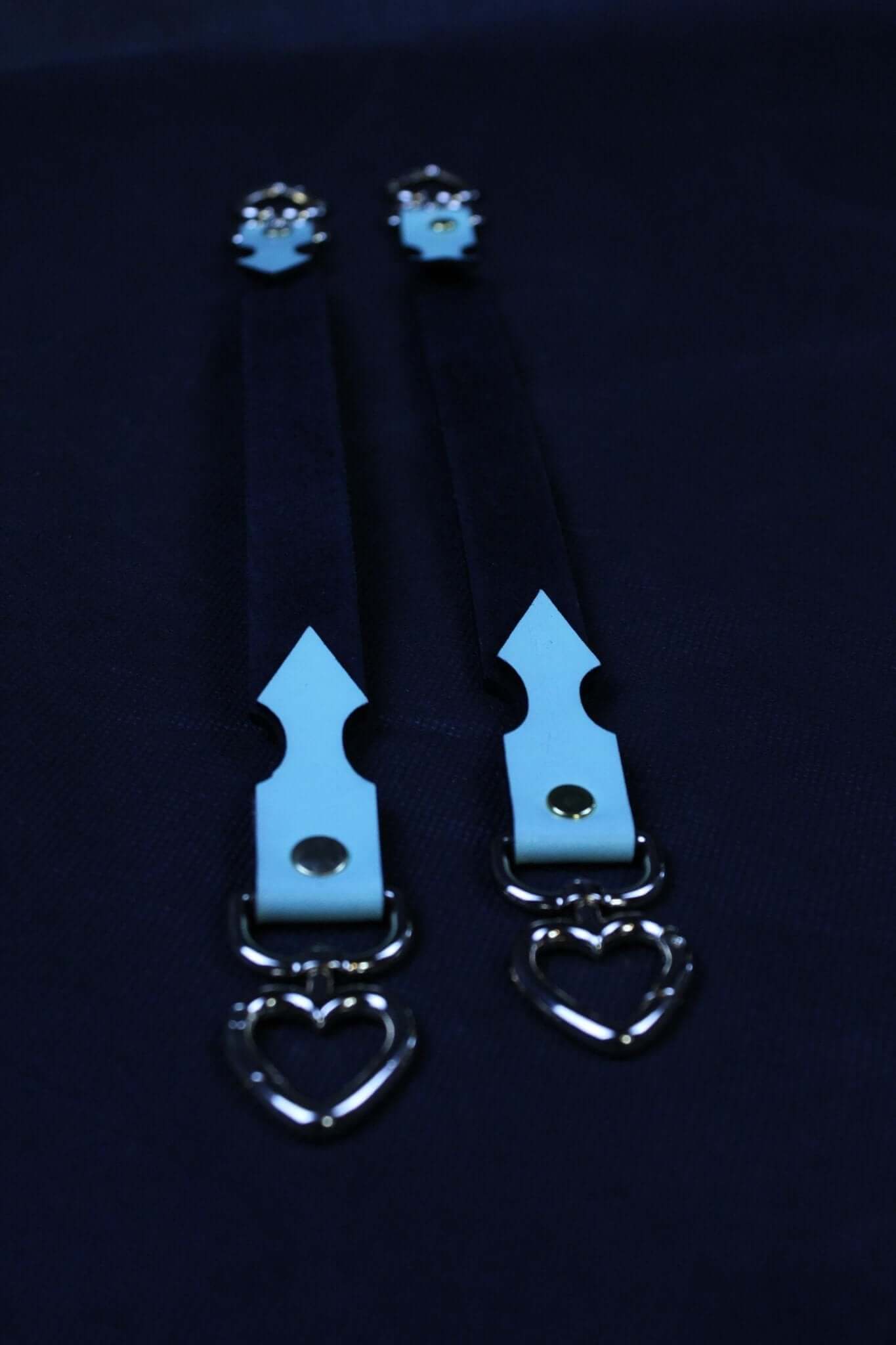 Short BDSM connector straps with heart-shaped hardware, perfect for bondage gear and restraint play.