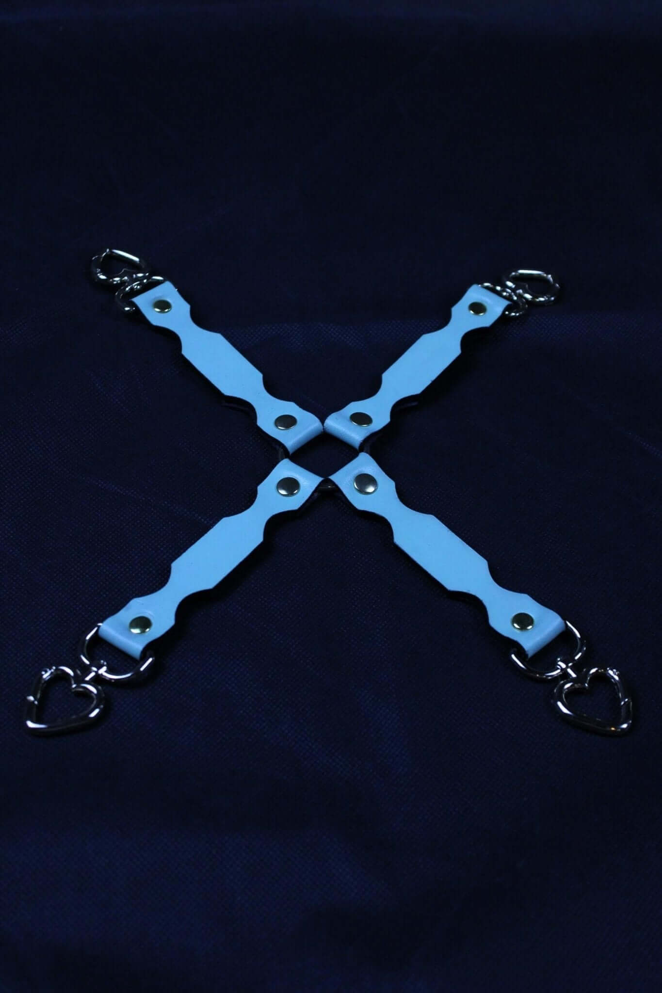Durable BDSM leather connector with heart clips, perfect for bondage play and restraint setups.