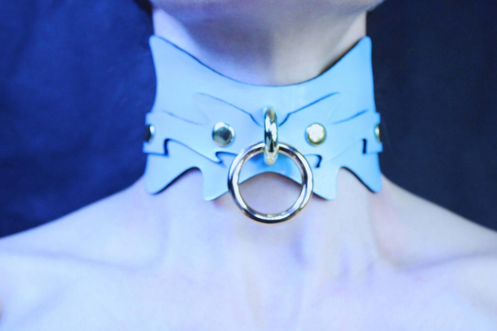 Sky blue submissive collar with gold O-ring, a striking BDSM accessory for petplay and bondage dynamics.