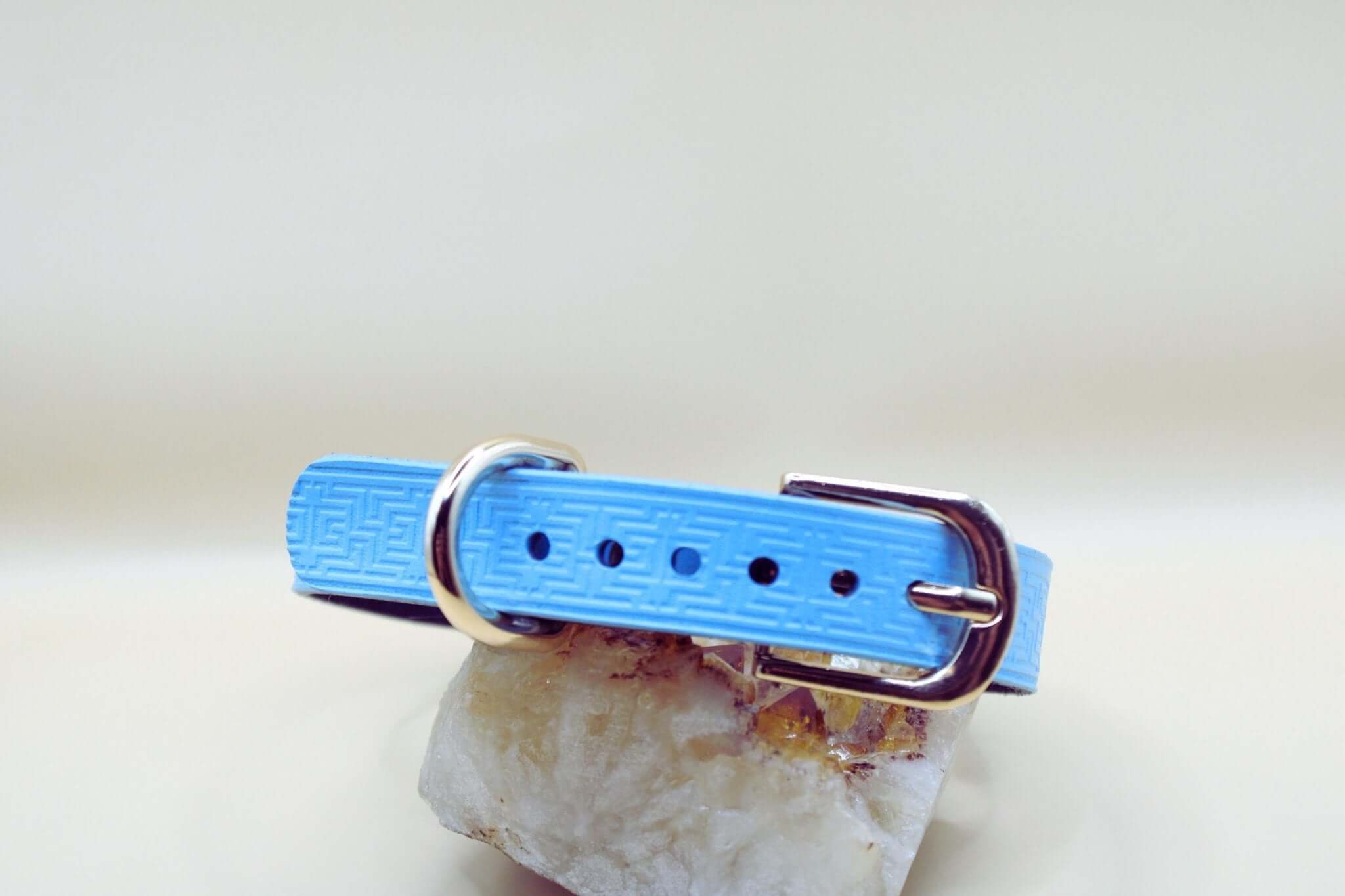 Sky blue leather submissive collar with geometric pattern and silver buckle, ideal for BDSM and discreet day wear.