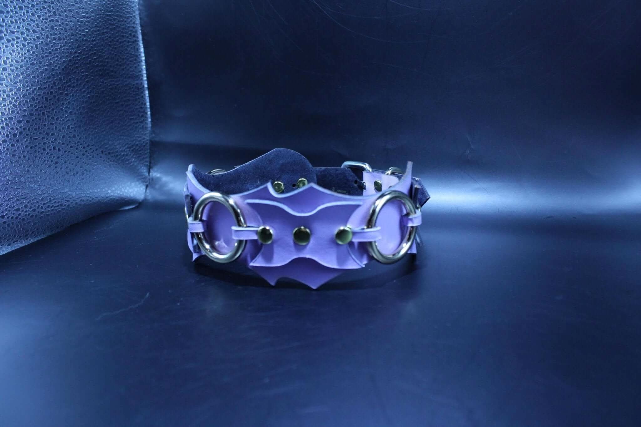 Stylish leather submissive collar with batwing design and O-rings, perfect for BDSM enthusiasts and bondage gear lovers.