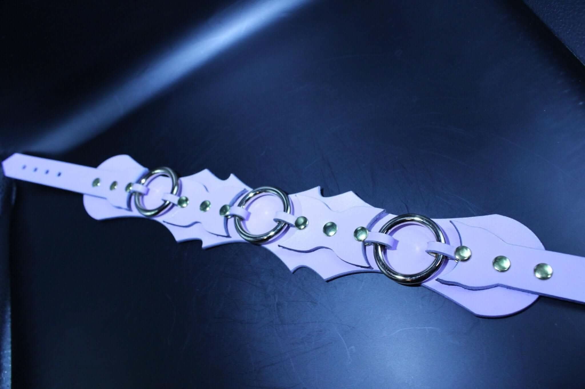 Unique lavender leather submissive collar with double-layered batwing design and central O-rings for BDSM.