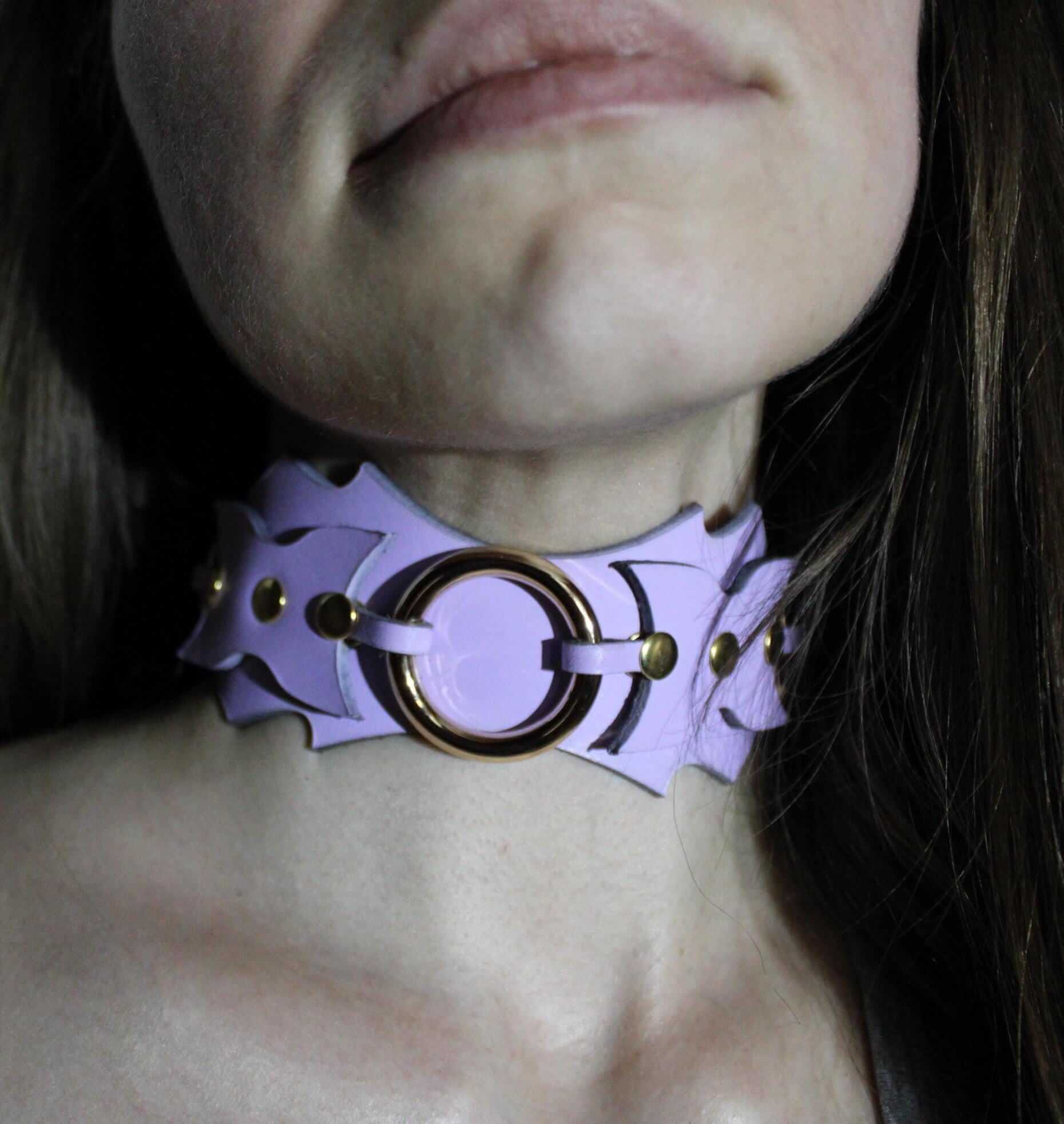 Bold leather sub collar with batwing design and O-ring for BDSM, perfect for submissive jewelry and bondage gear.