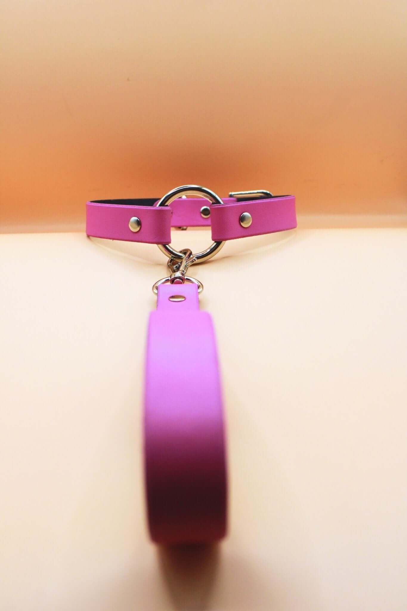 Elegant pink leather submissive collar necklace with leash, perfect for discreet daywear and BDSM accessories.
