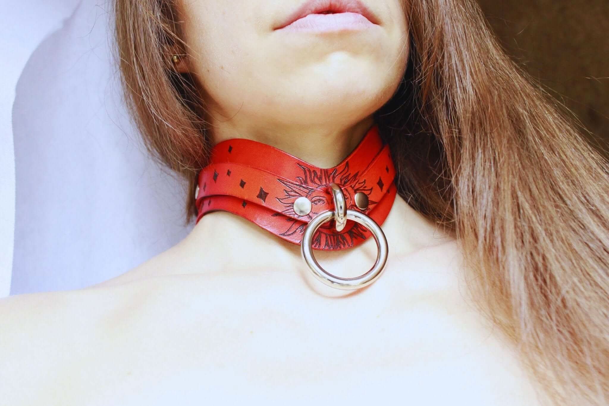Exquisite Sun Design BDSM collar in red leather, perfect as a discreet day collar for submissive jewelry enthusiasts.