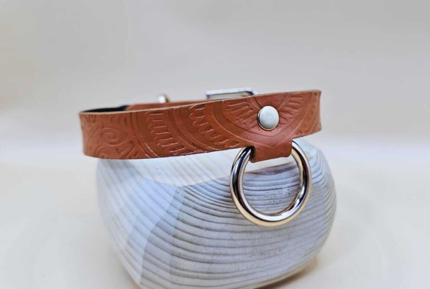 Handcrafted tan BDSM collar with embossed patterns, perfect for submissive jewelry and discreet day wear.