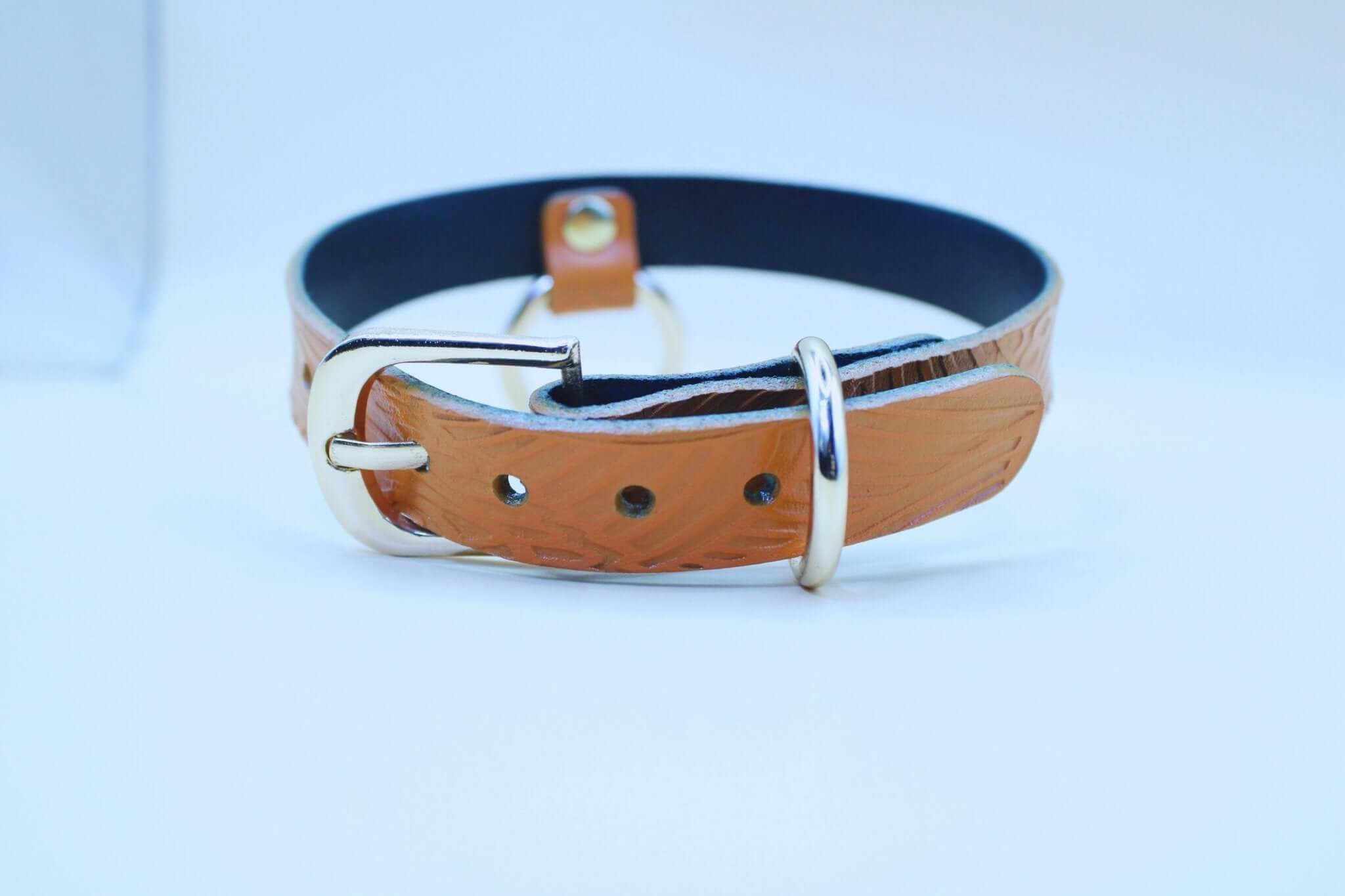 Tan leather BDSM collar with embossed patterns, perfect for submissive jewelry and discreet day wear.