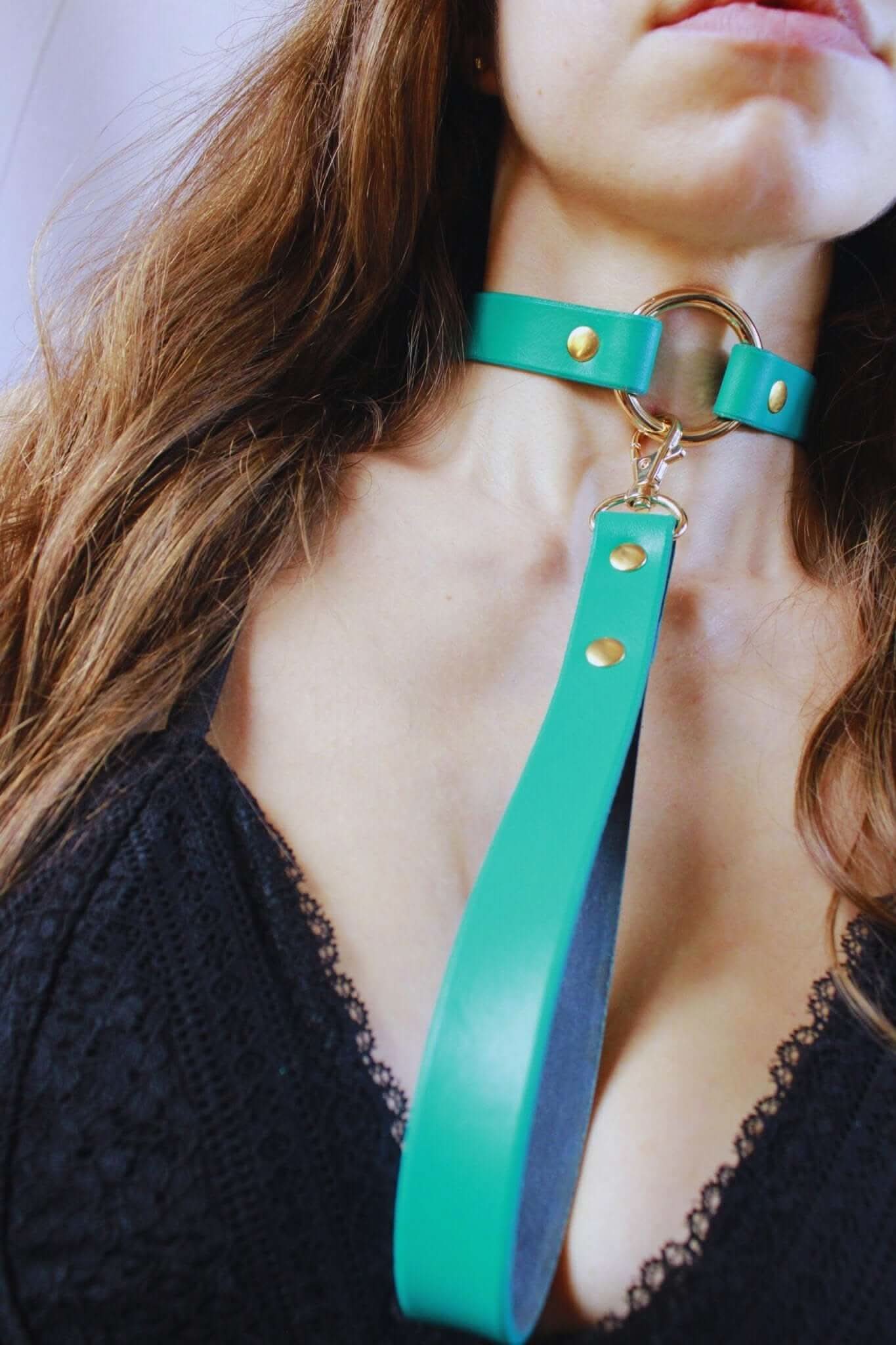 Turquoise leather BDSM collar with leash, ideal for discreet day wear, showcasing elegance in submissive jewelry.