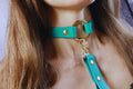 Turquoise leather submissive collar with gold accents, perfect for discreet day wear and BDSM play.