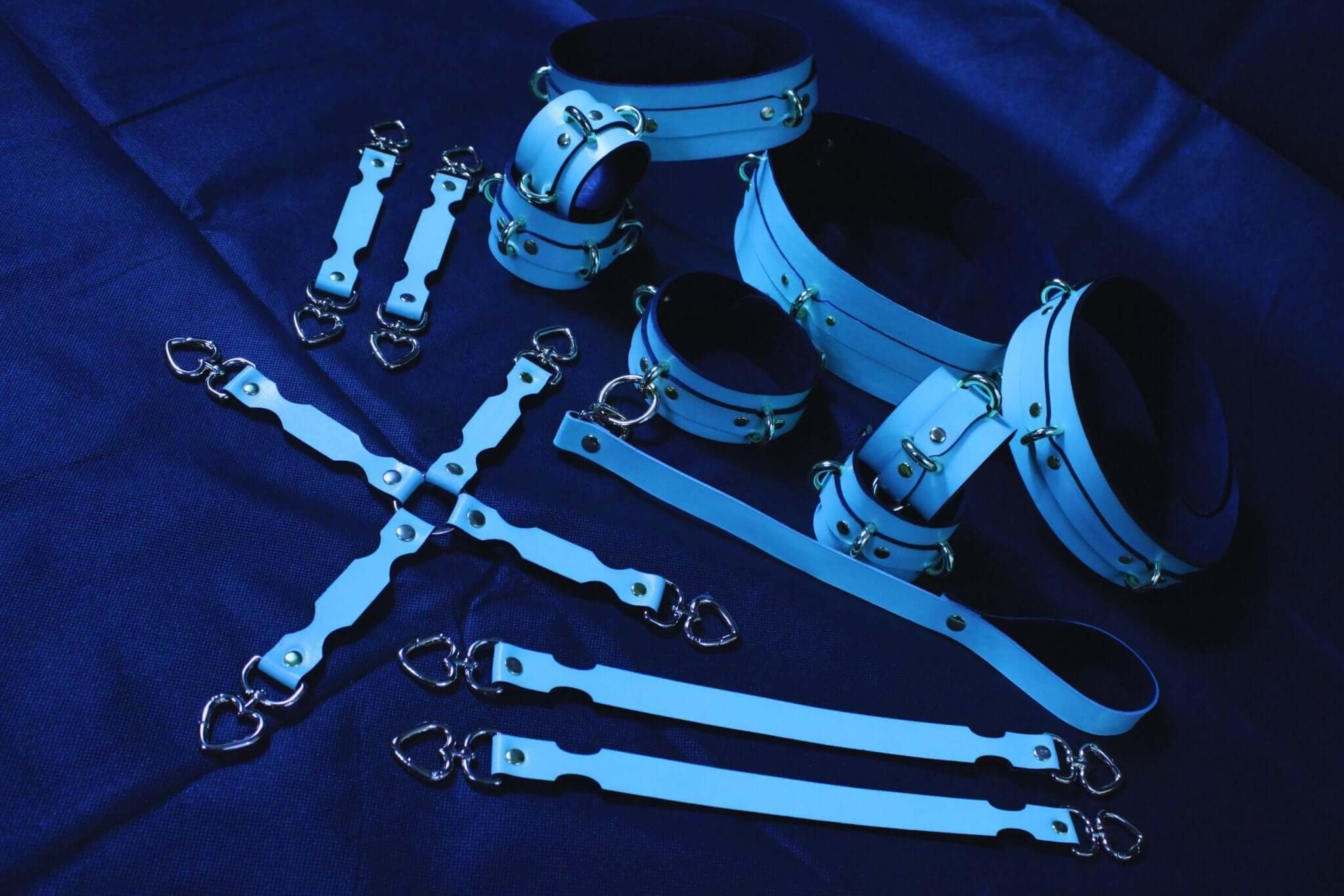 Ultimate BDSM bondage gear set in blue Italian leather including cuffs, collar, harness, and connectors for erotic exploration.